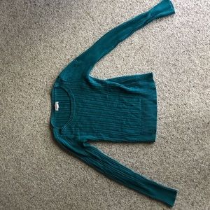 blue open neck sweater